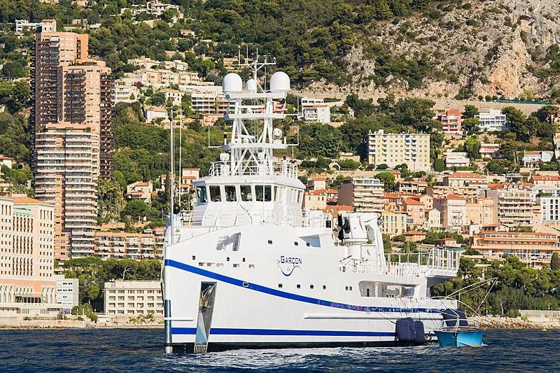 a large white boat in the water aboard GARCON Yacht for Sale