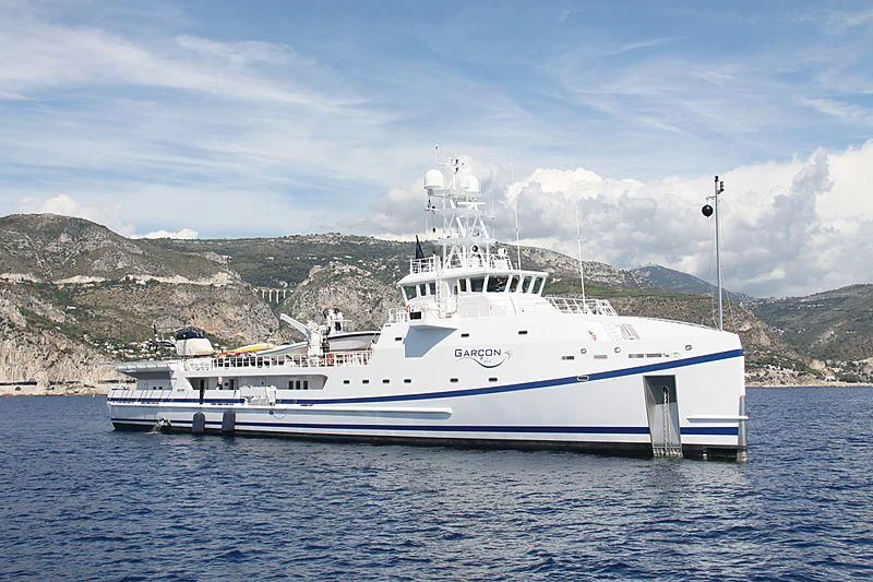 a large white boat on the water aboard GARCON Yacht for Sale