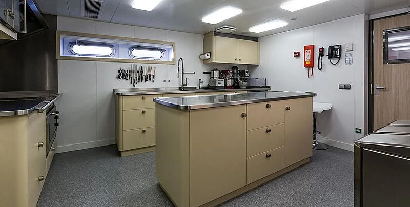 a kitchen with a sink and cabinets aboard GARCON Yacht for Sale