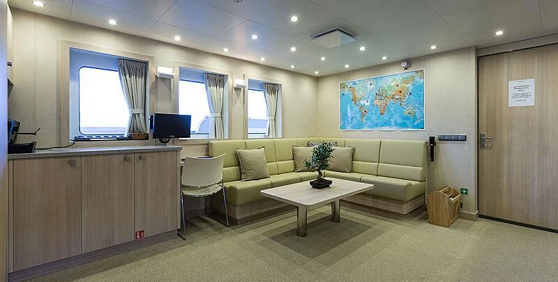 a living room with a couch and a coffee table aboard GARCON Yacht for Sale