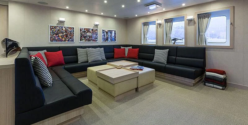 a living room with a couch and a coffee table aboard GARCON Yacht for Sale