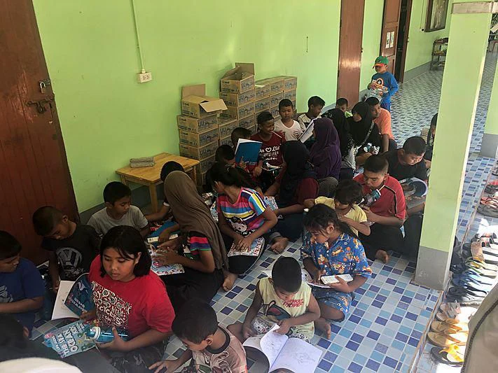 a group of children sitting in a classroom aboard GARCON Yacht for Sale