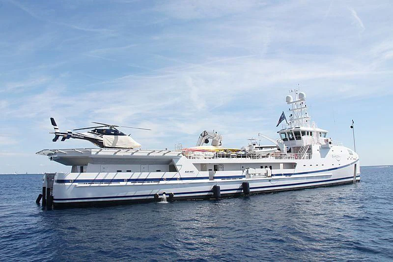 a white yacht in the water aboard GARCON Yacht for Sale