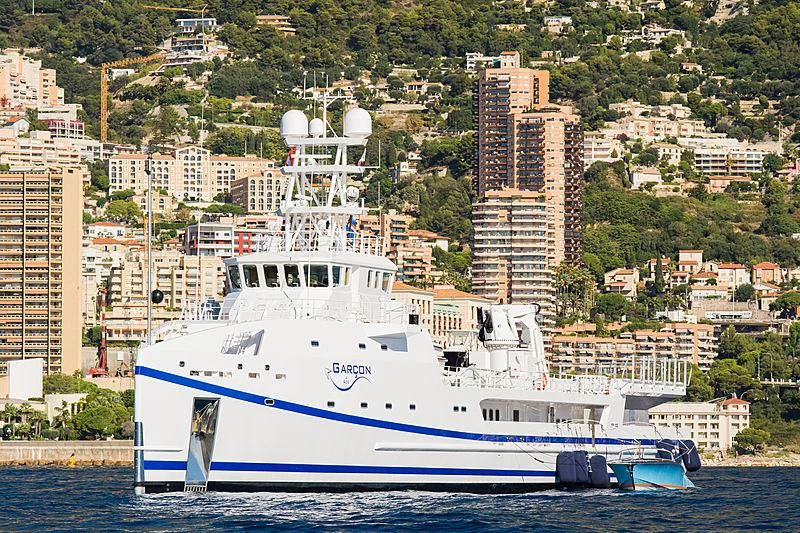 a large white boat in the water aboard GARCON Yacht for Sale