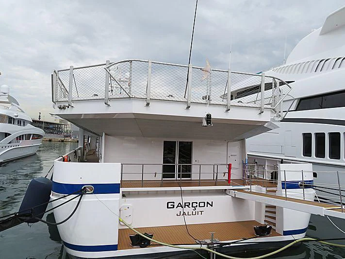 a boat docked at a pier aboard GARCON Yacht for Sale