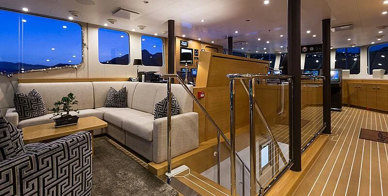 a living room with a large glass door aboard GARCON Yacht for Sale