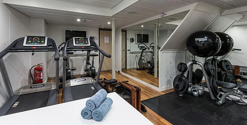a room with a large gym aboard GARCON Yacht for Sale