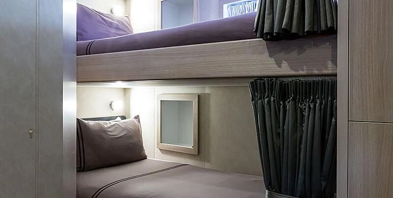 a room with a bed and a window aboard GARCON Yacht for Sale