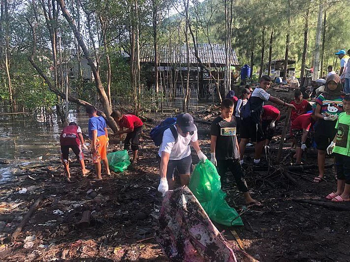 a group of people working in a forest aboard GARCON Yacht for Sale