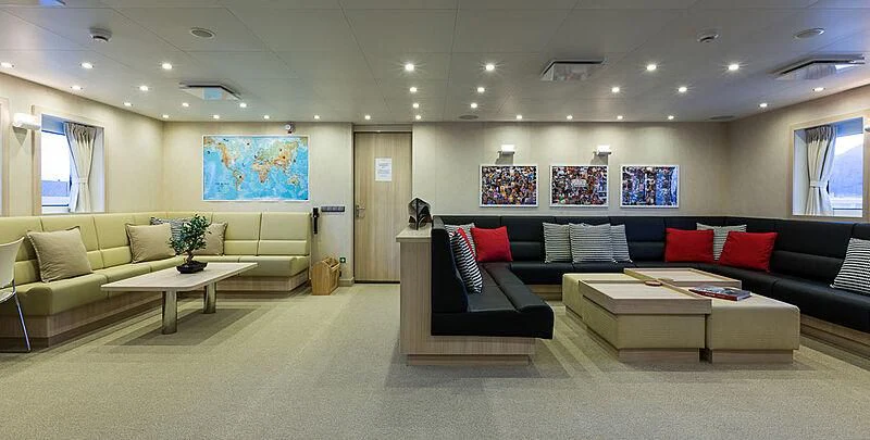 a large living room with a couch and a coffee table aboard GARCON Yacht for Sale