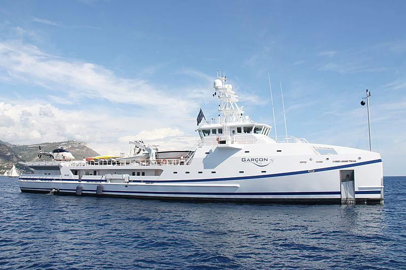 a large white boat in the water aboard GARCON Yacht for Sale