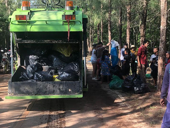 a group of people standing around a vehicle with a green tank aboard GARCON Yacht for Sale