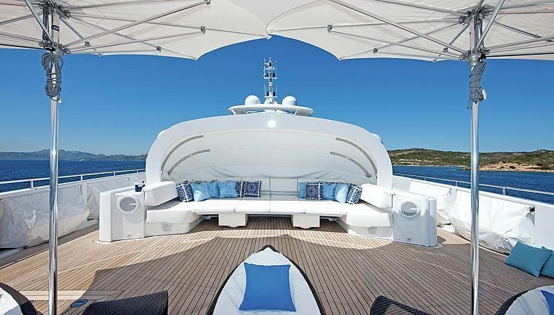a white boat on a deck aboard R JUNIORS Yacht for Sale