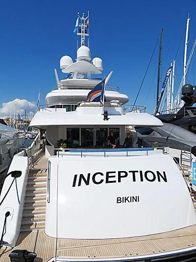 a white boat with a blue stripe aboard R JUNIORS Yacht for Sale