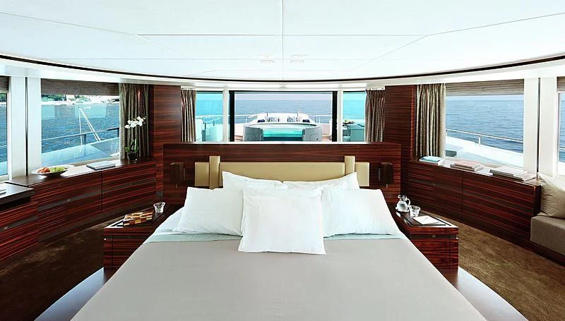a bed with white sheets and pillows aboard R JUNIORS Yacht for Sale