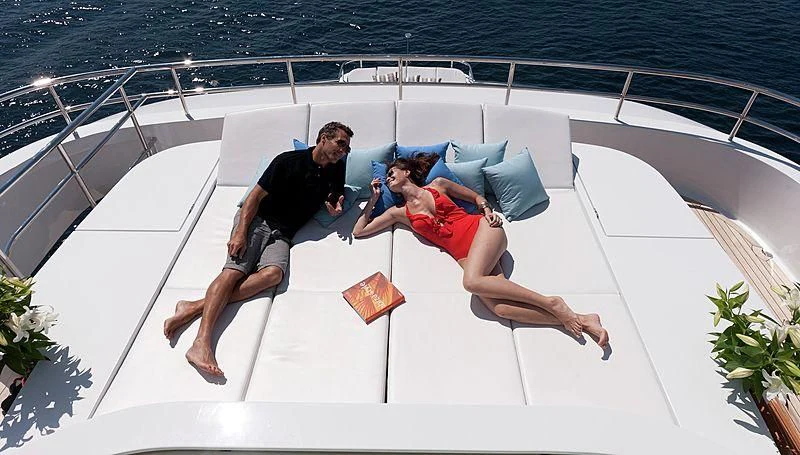 a man and a woman jumping on a boat aboard R JUNIORS Yacht for Sale
