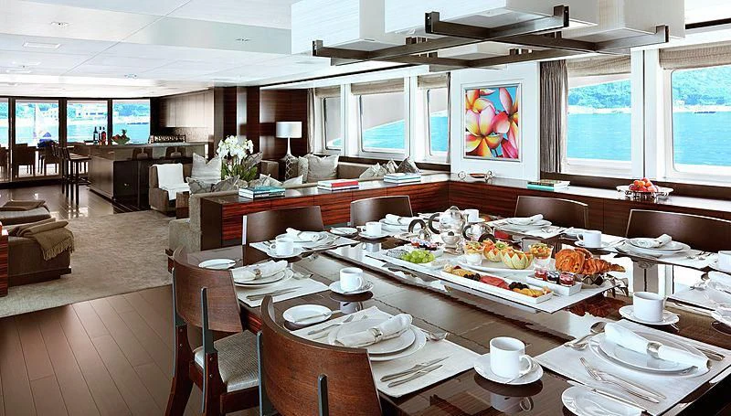a large dining room with a table set for a meal aboard R JUNIORS Yacht for Sale