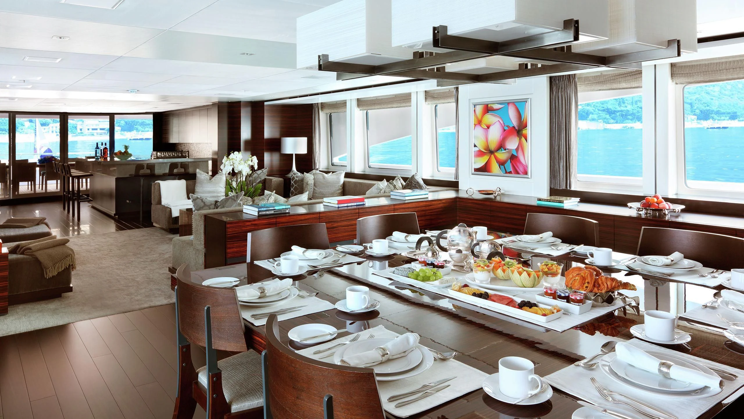 a large room with tables and chairs aboard R JUNIORS Yacht for Sale