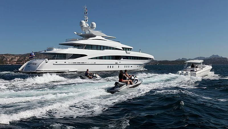 a boat in the water with a boat in the background aboard R JUNIORS Yacht for Sale
