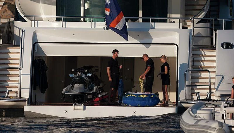 a group of people standing in a garage aboard R JUNIORS Yacht for Sale