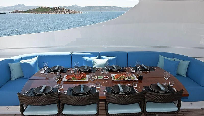 a table set for a meal on a beach aboard R JUNIORS Yacht for Sale