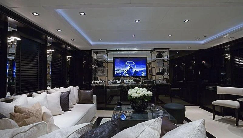 a living room with a large screen aboard G-FORCE Yacht for Sale