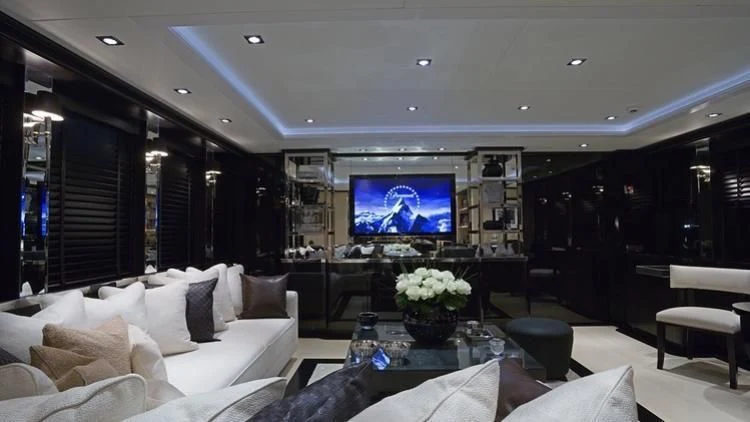 a living room with a large screen aboard G-FORCE Yacht for Sale