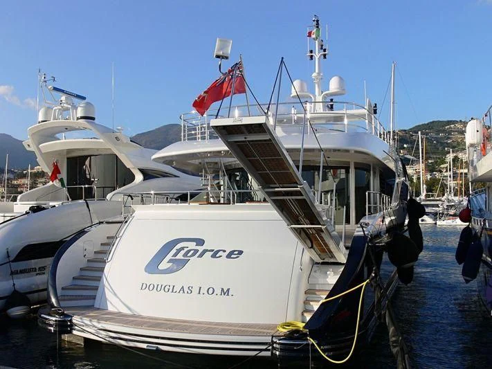a boat with a flag on the front aboard G-FORCE Yacht for Sale