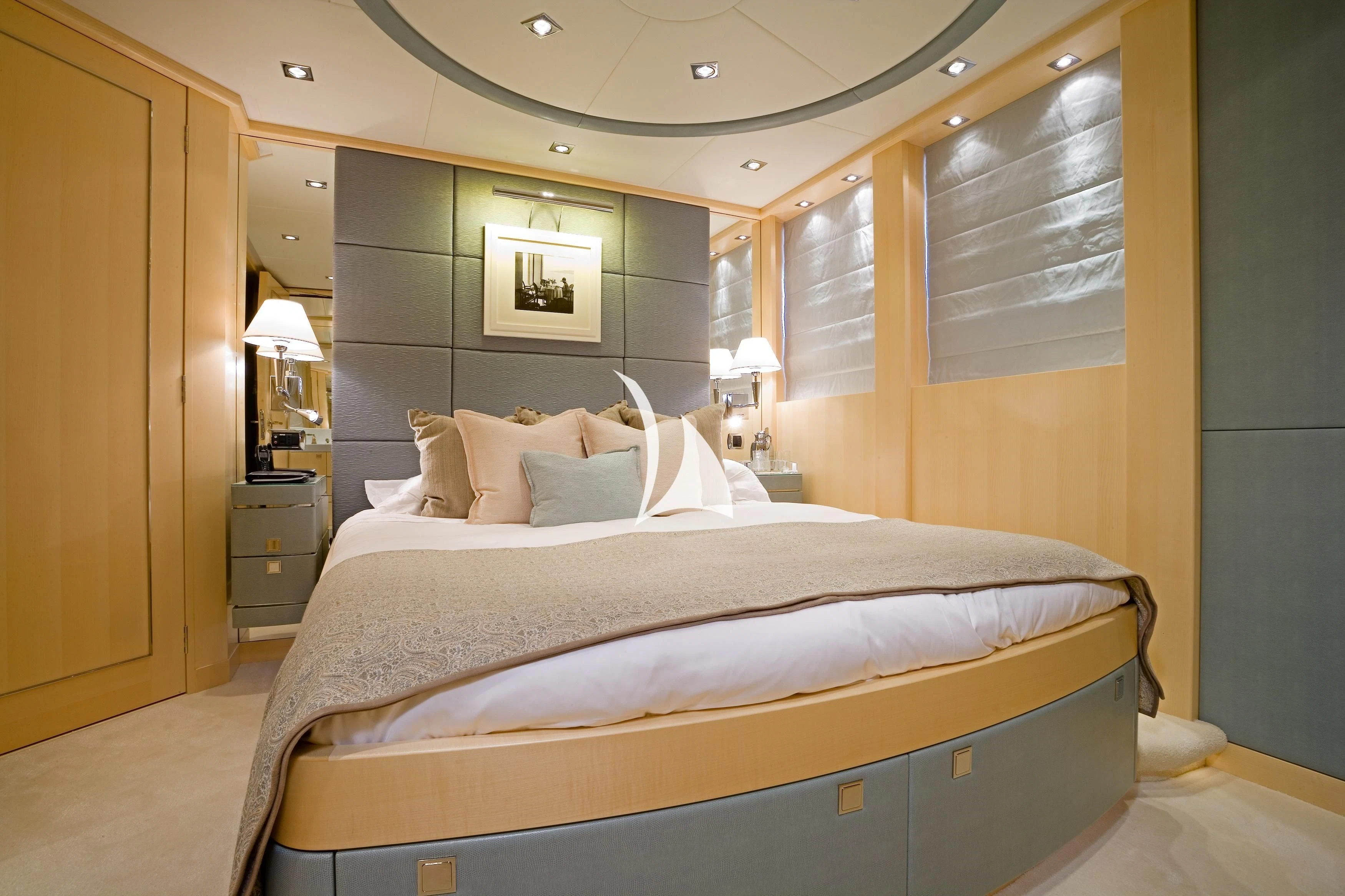 a bed with a white sheet and pillows aboard G-FORCE Yacht for Sale