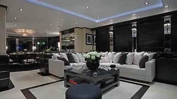 a living room with a couch and a coffee table aboard G-FORCE Yacht for Sale