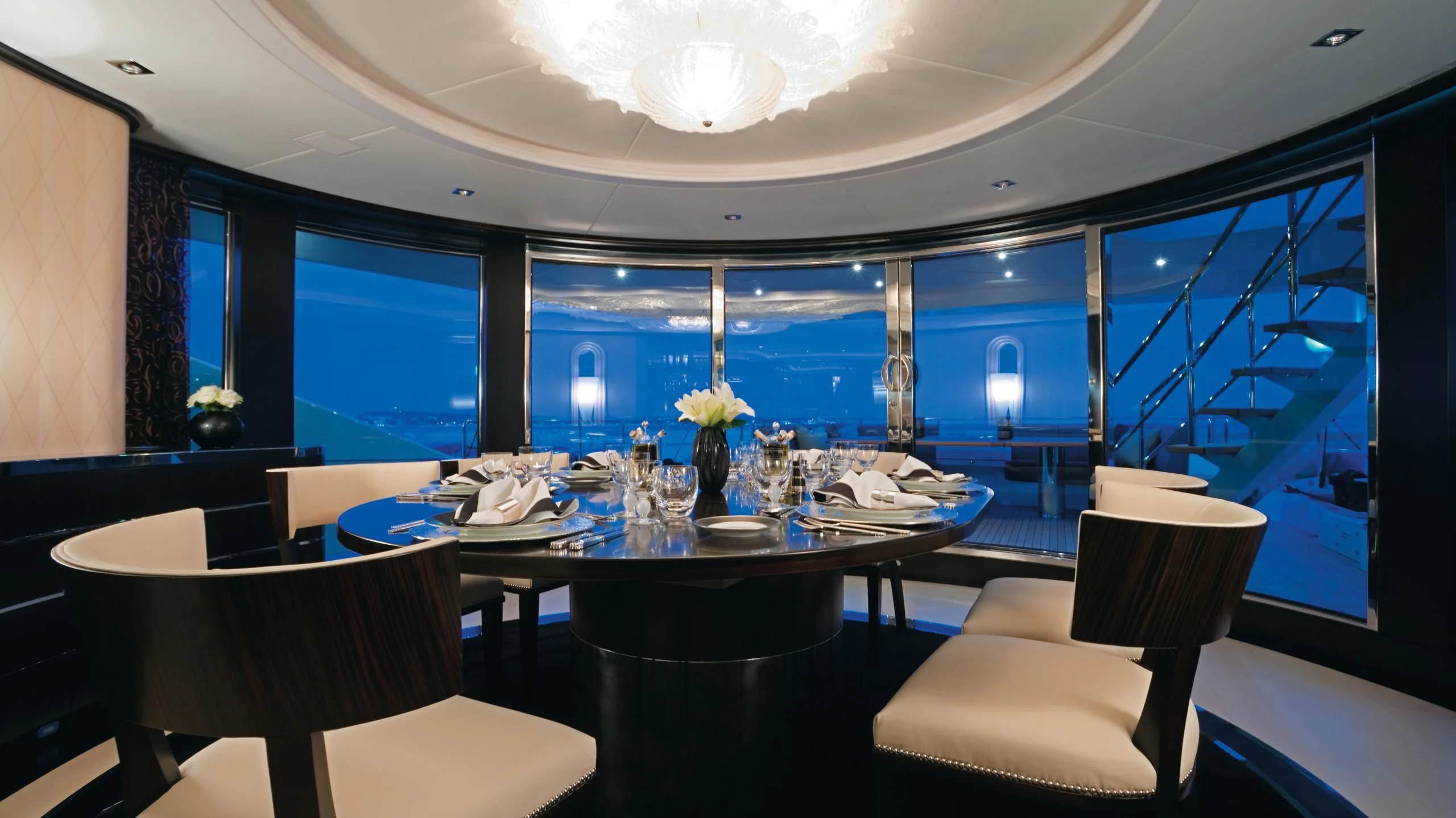 a room with a table and chairs aboard G-FORCE Yacht for Sale