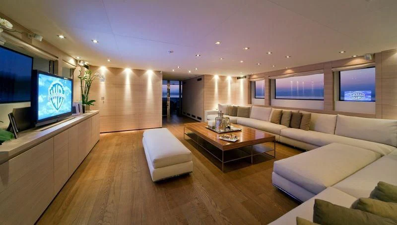 a living room with a large screen aboard FAN TOO Yacht for Sale
