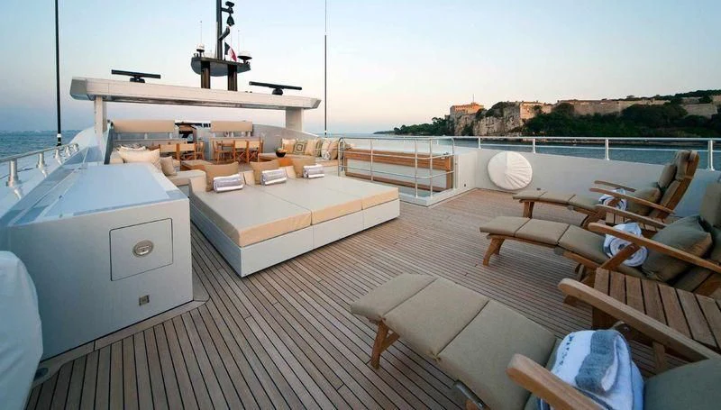 a deck with a bed and a large white machine on it aboard FAN TOO Yacht for Sale