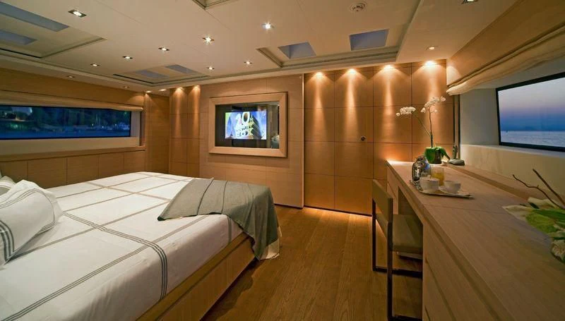 a room with a bed and a tv aboard FAN TOO Yacht for Sale