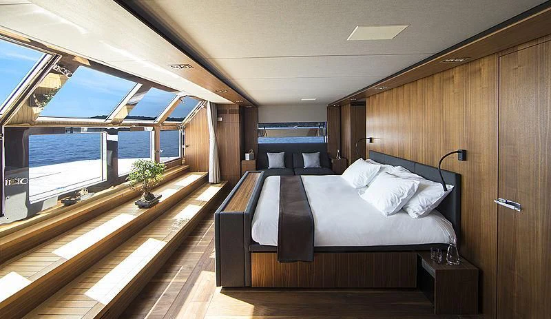 a room with a bed and a window aboard KANGA Yacht for Sale