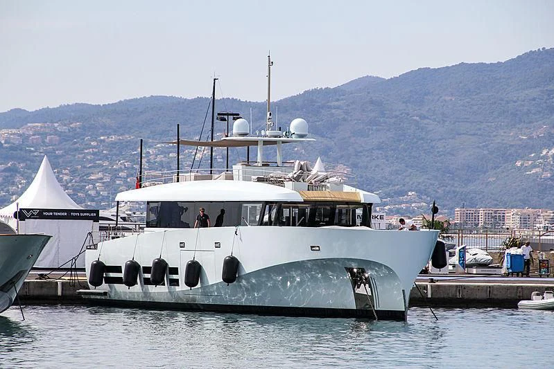 a large white boat on a body of water aboard KANGA Yacht for Sale