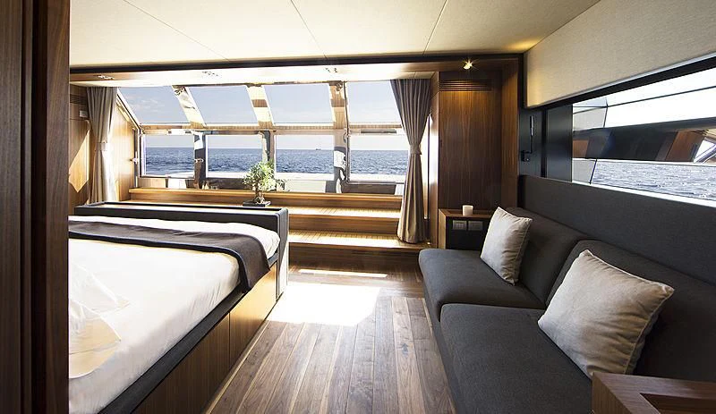 a room with a bed and a couch aboard KANGA Yacht for Sale