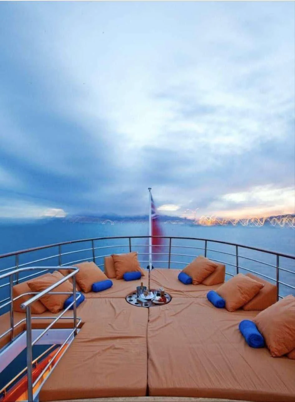 a deck with a view of the water and a beach aboard CAMARA C Yacht for Sale