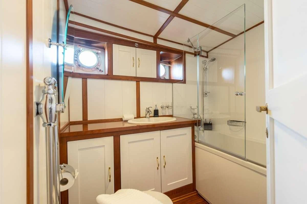a bathroom with a sink and shower aboard CAMARA C Yacht for Sale