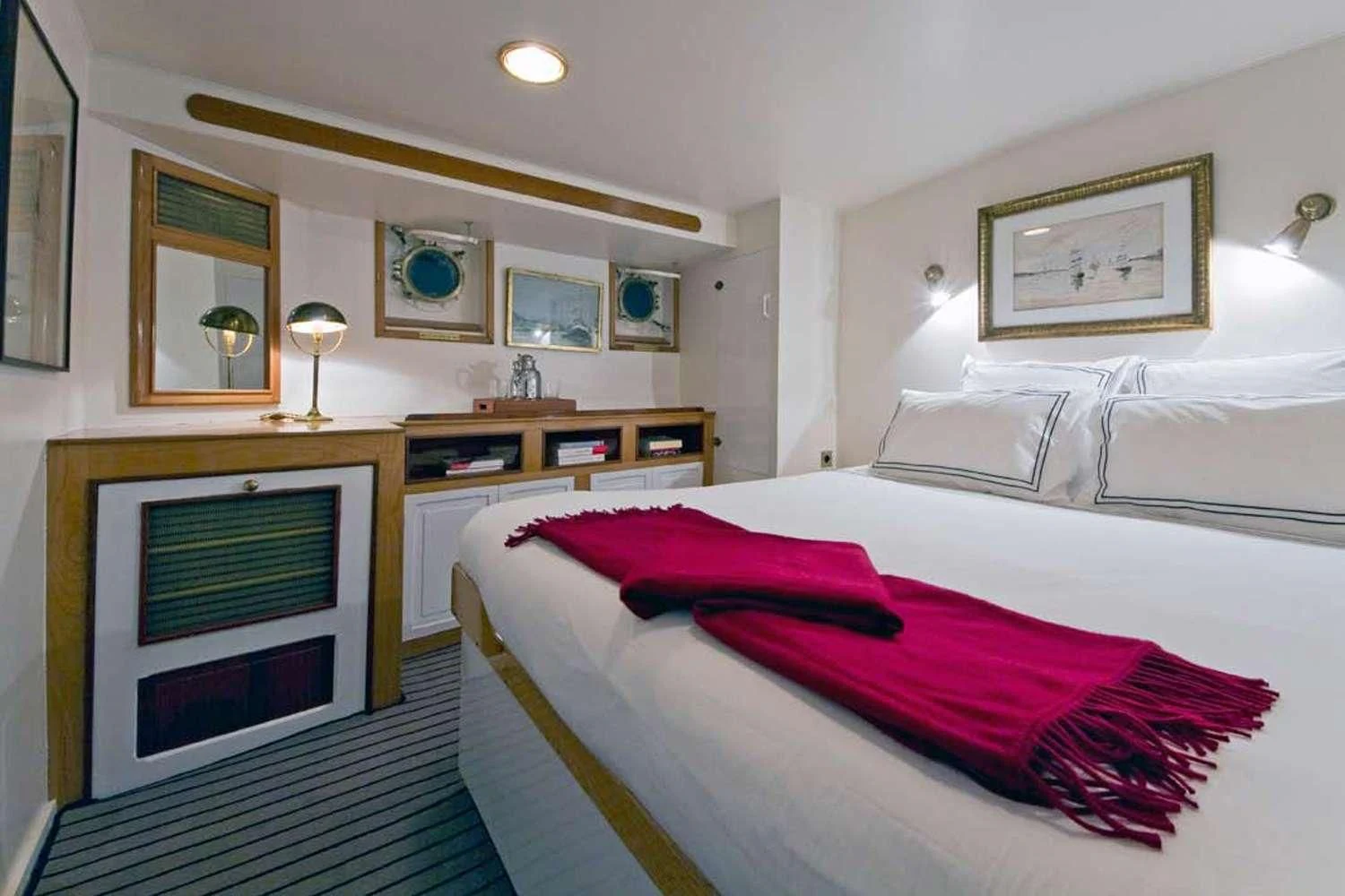 a bedroom with a fireplace aboard CAMARA C Yacht for Sale