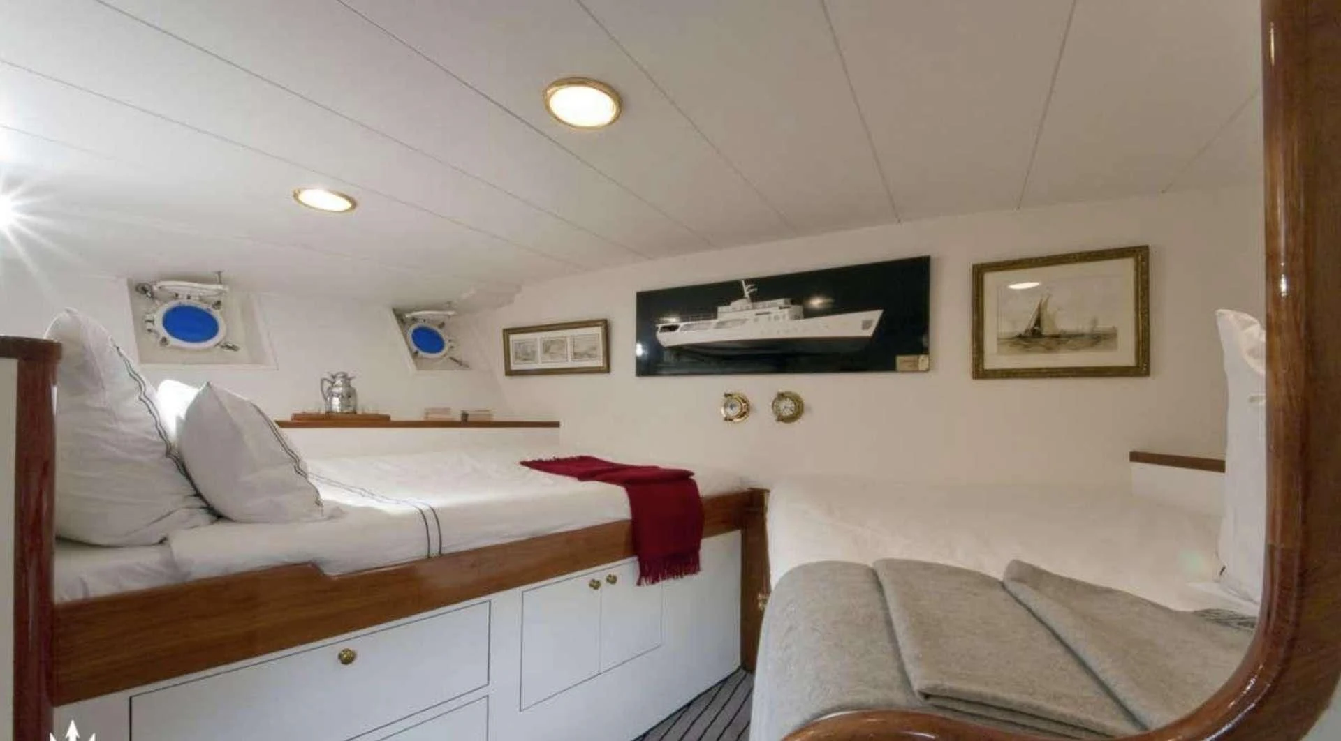 a room with a bed and a television on the wall aboard CAMARA C Yacht for Sale