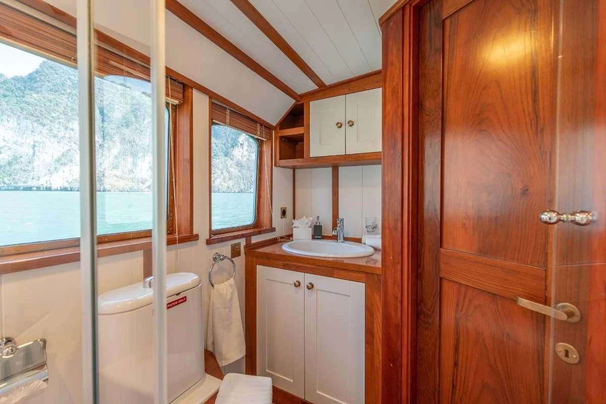 a bathroom with a wood cabinet aboard CAMARA C Yacht for Sale