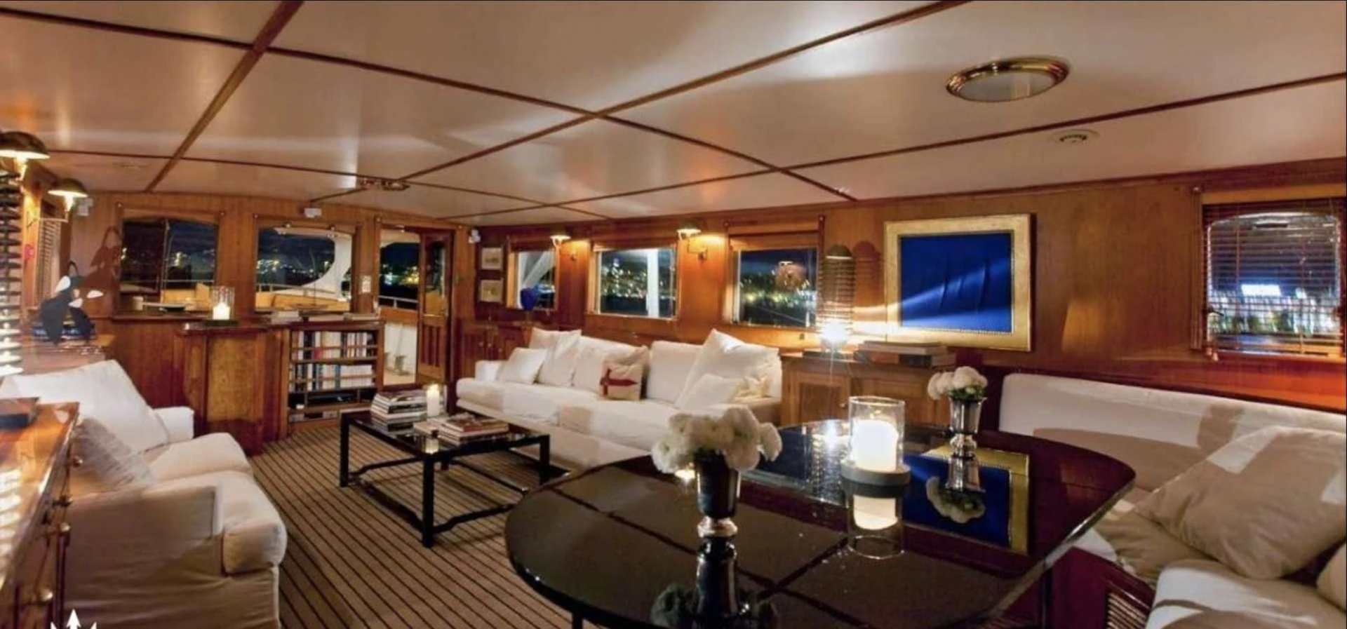 a living room with a large screen aboard CAMARA C Yacht for Sale