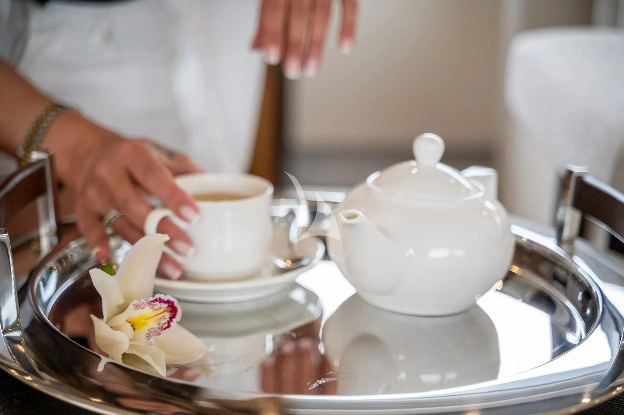 a person pouring a liquid into a cup aboard PAREAKI II Yacht for Sale
