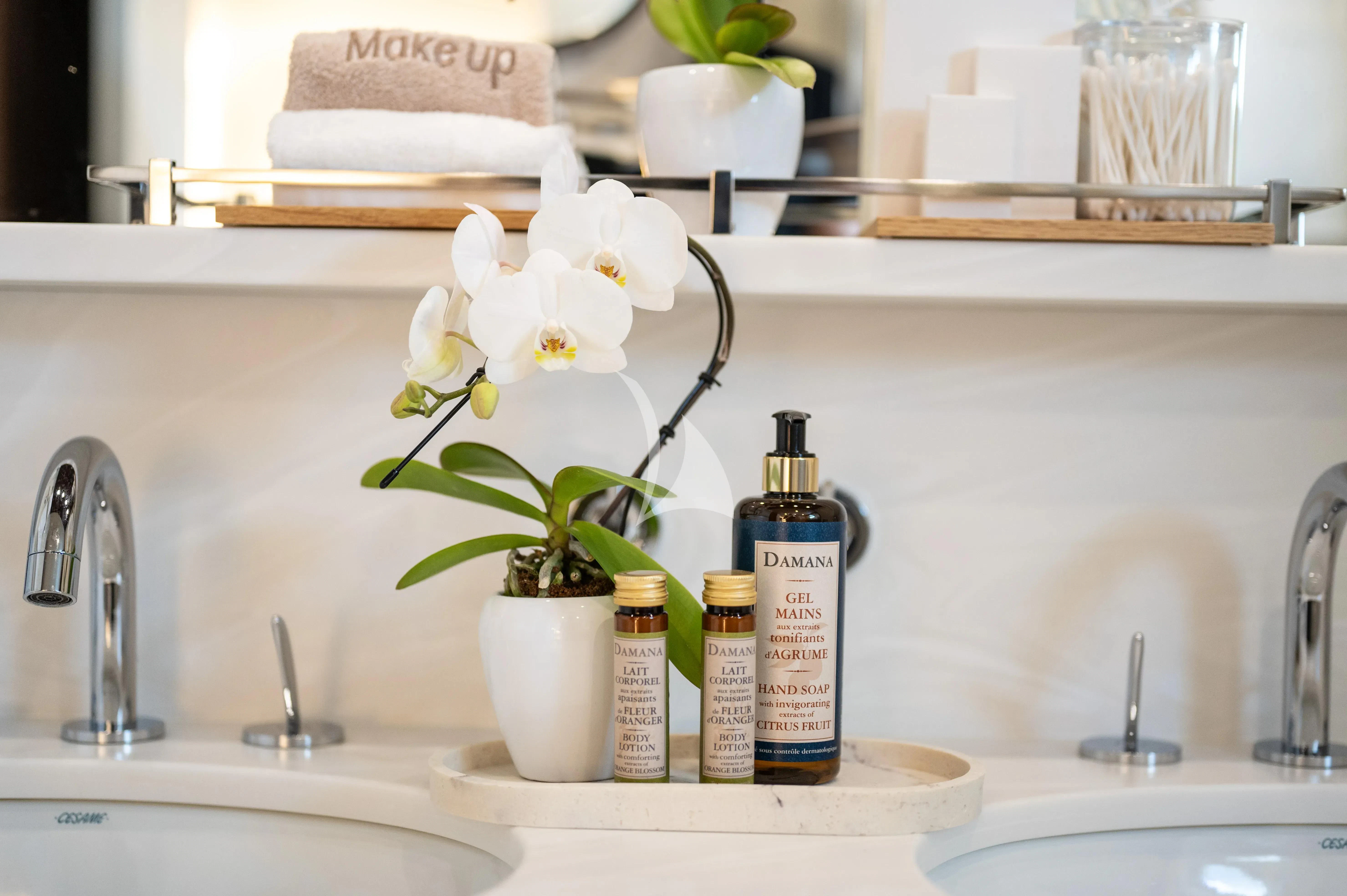 a sink with a flower vase and a bottle of perfume aboard PAREAKI II Yacht for Sale