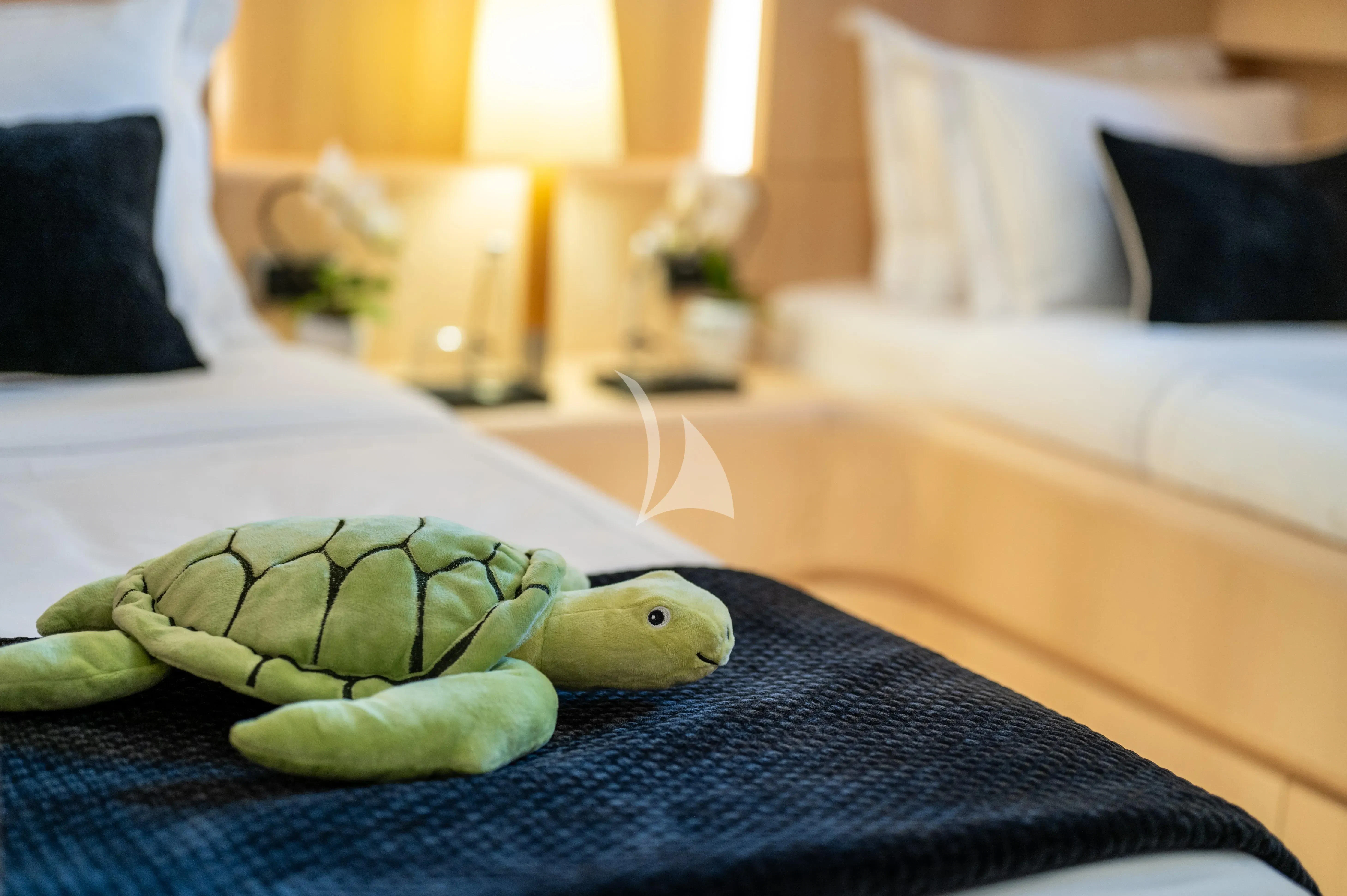 a green snake on a bed aboard PAREAKI II Yacht for Sale