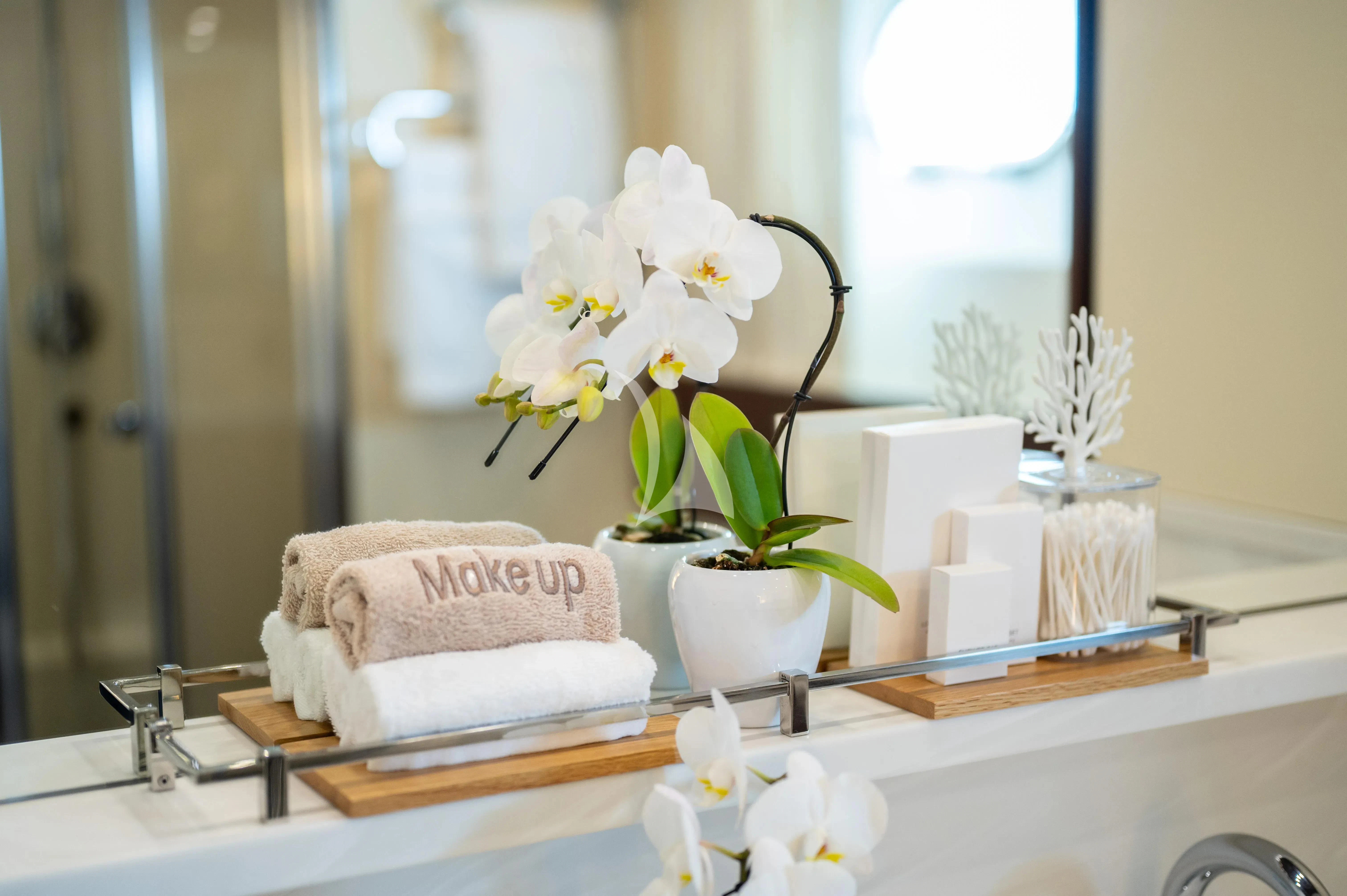a table with a vase of flowers and a candle aboard PAREAKI II Yacht for Sale