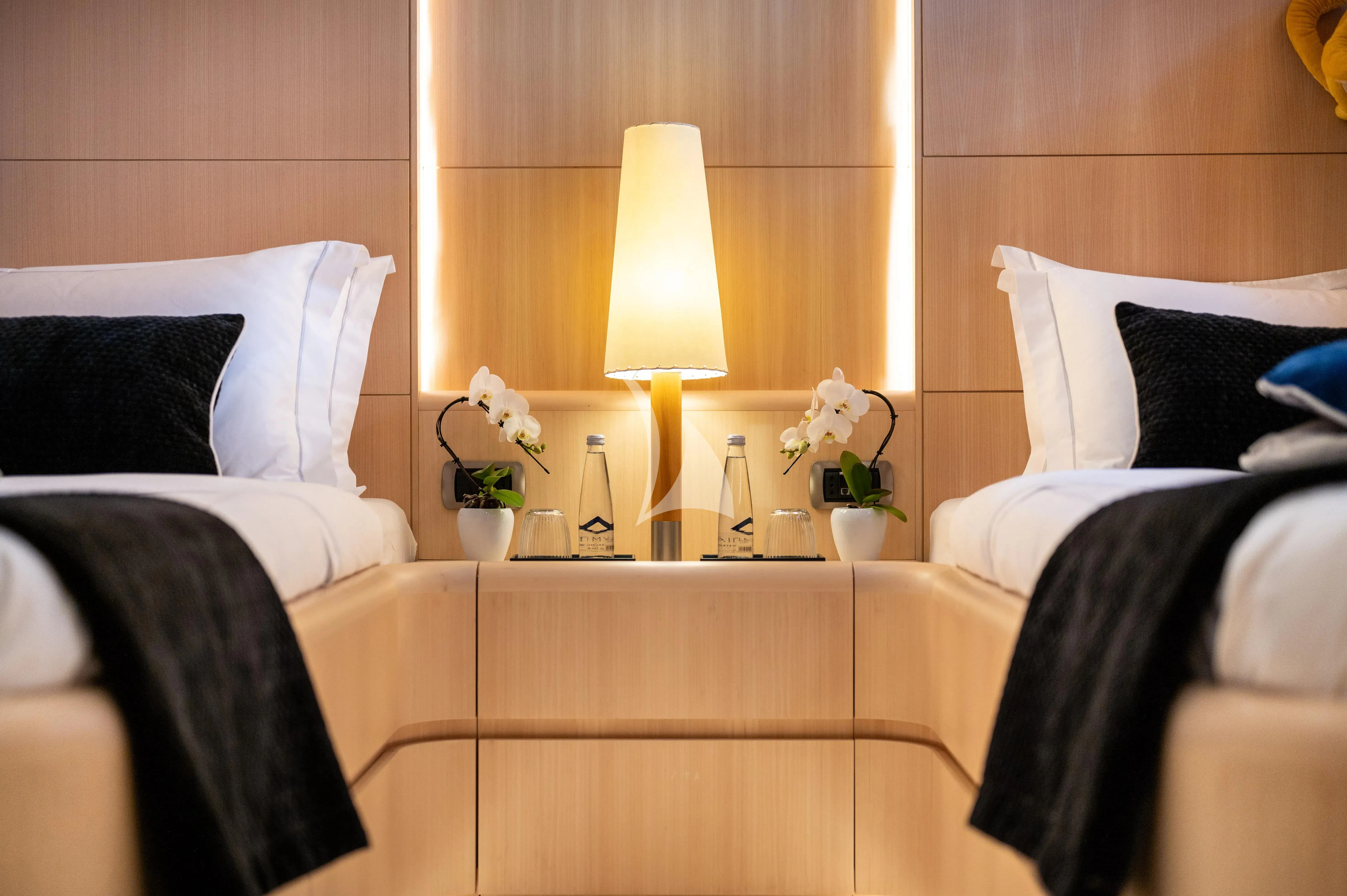 a room with a bed and a lamp aboard PAREAKI II Yacht for Sale