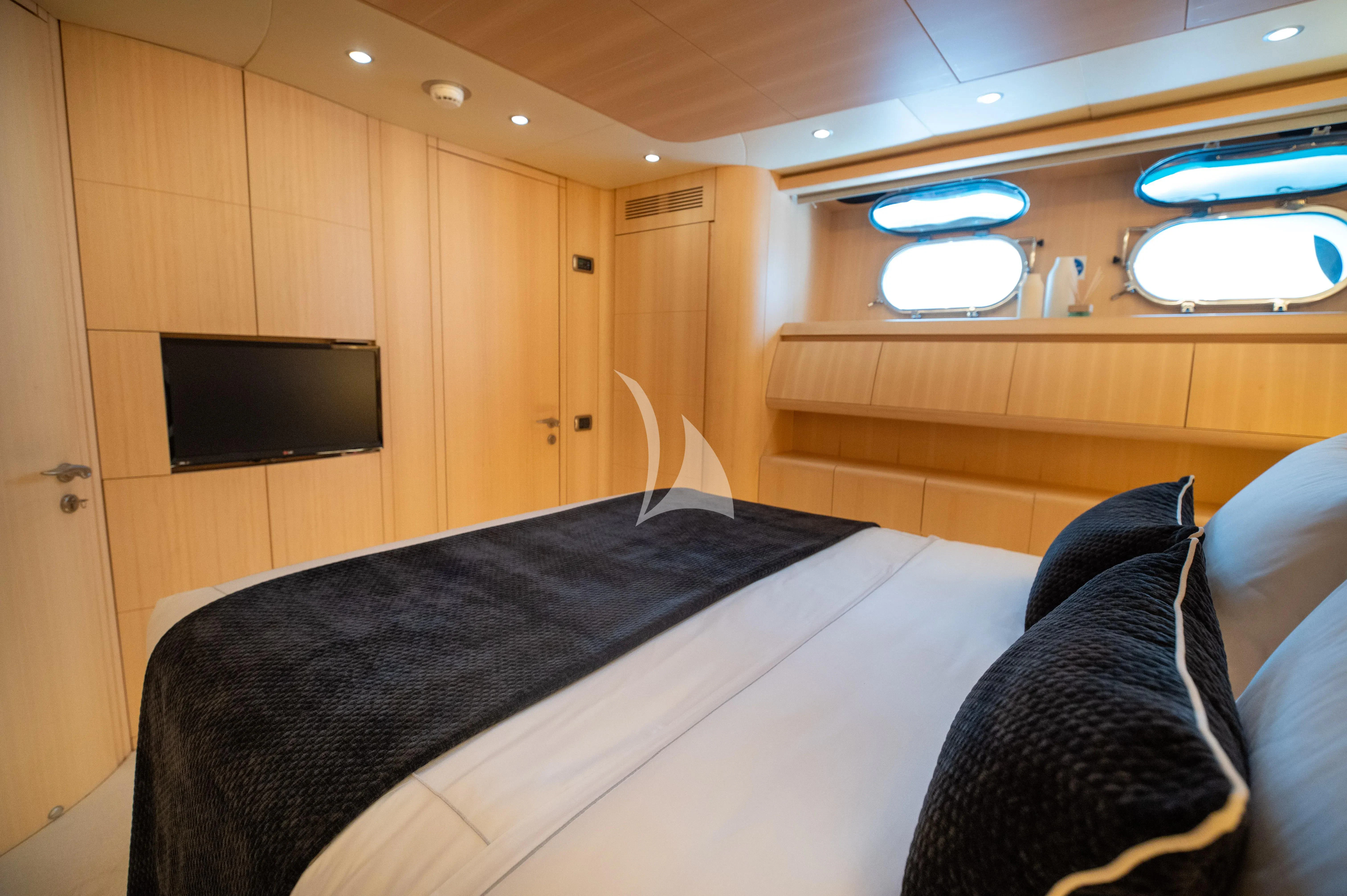 a bedroom with a bed and tv aboard PAREAKI II Yacht for Sale