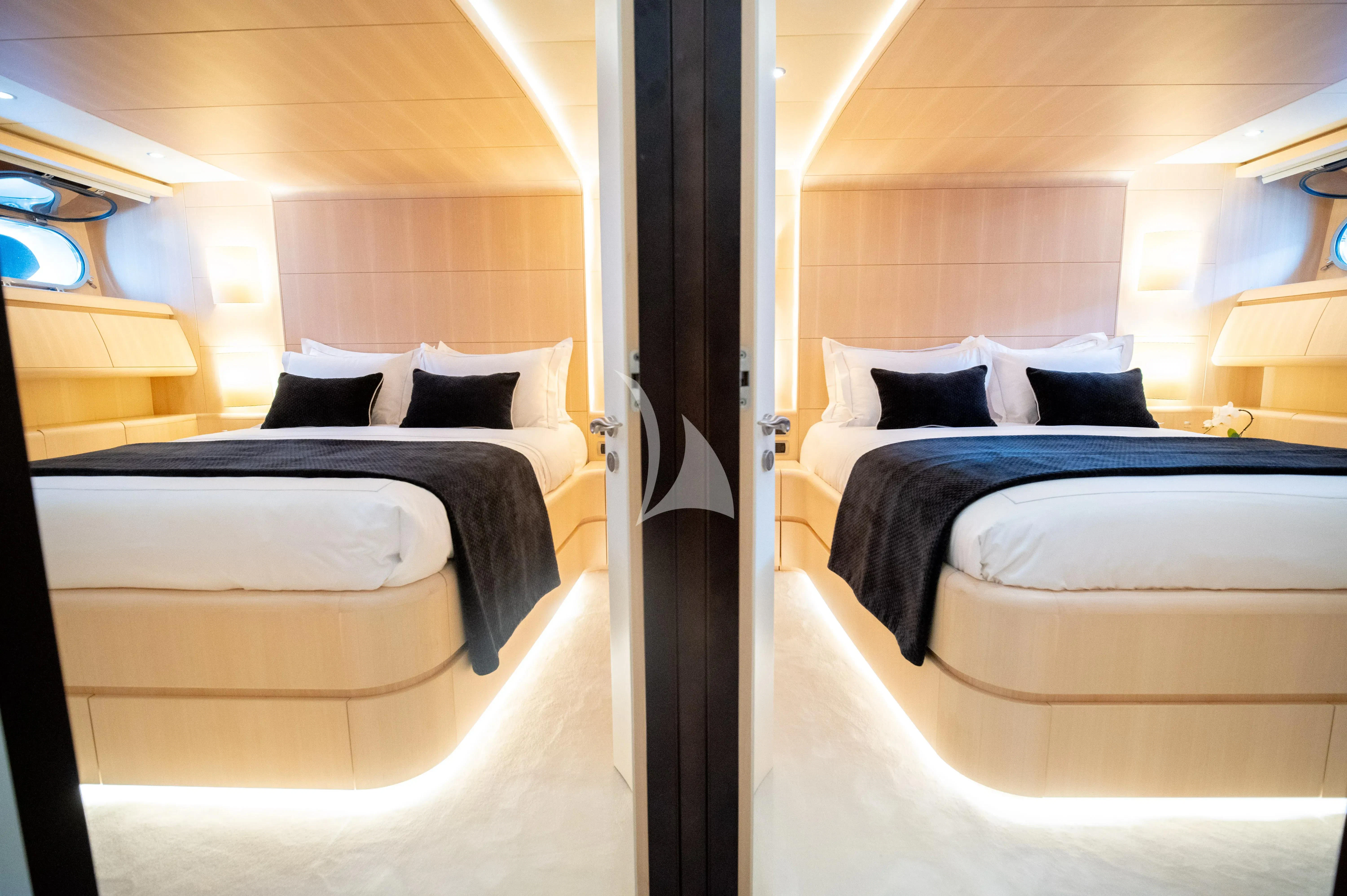 a room with beds and a window aboard PAREAKI II Yacht for Sale
